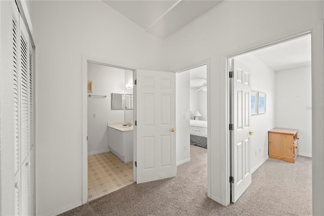 hallway with light colored carpet