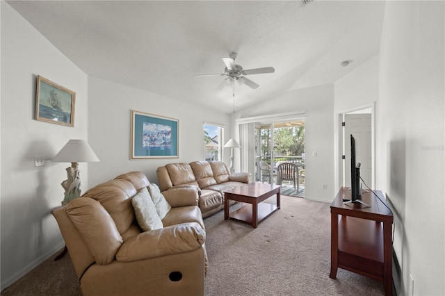 carpeted living room featuring ceiling fan, vaulted ceiling, and a textured ceiling