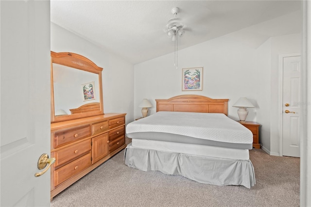 bedroom featuring lofted ceiling, light colored carpet, and ceiling fan