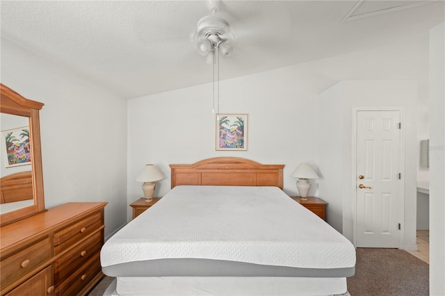 bedroom featuring carpet floors, a textured ceiling, vaulted ceiling, and ceiling fan