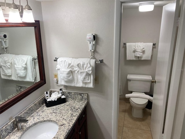 bathroom featuring vanity, toilet, and tile patterned floors