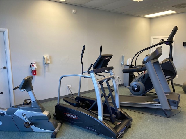 exercise room with a paneled ceiling