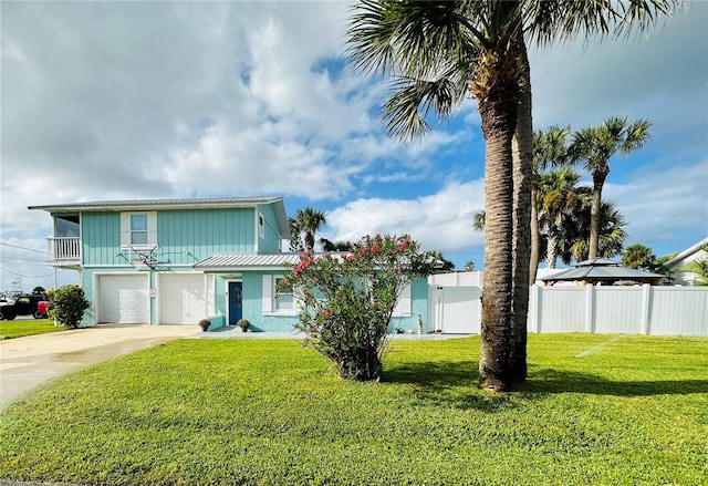 view of front of house with a garage and a front lawn