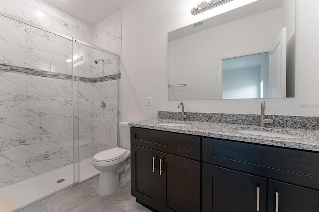 bathroom with vanity, a shower with shower door, and toilet