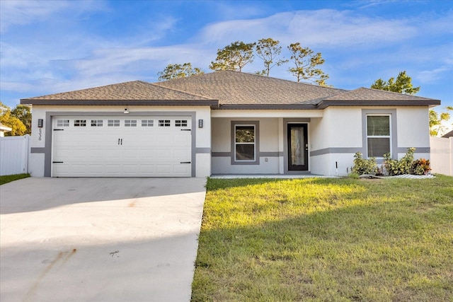 view of front of home featuring a front lawn and a garage