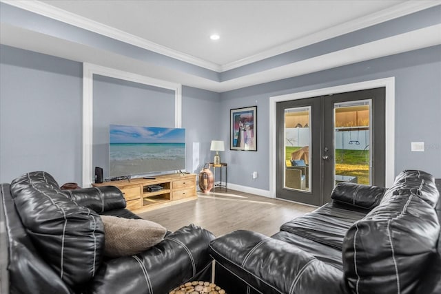 living room with french doors, crown molding, and hardwood / wood-style floors