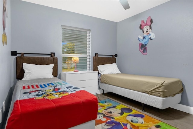 bedroom with dark hardwood / wood-style floors and ceiling fan