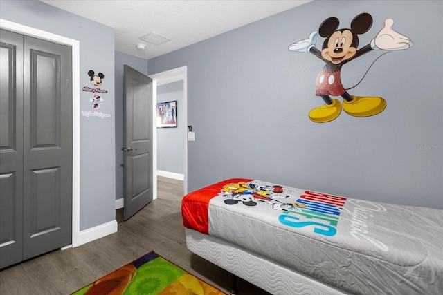 bedroom with dark wood-type flooring