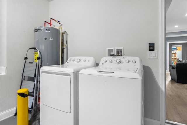 laundry area featuring hardwood / wood-style floors and washing machine and clothes dryer