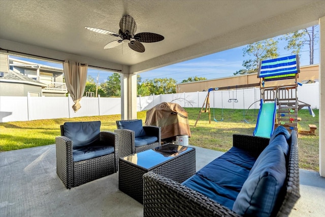 view of patio / terrace featuring a playground and ceiling fan