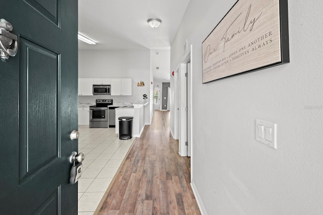 corridor with light hardwood / wood-style flooring