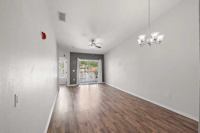 spare room with ceiling fan with notable chandelier, lofted ceiling, and dark hardwood / wood-style floors