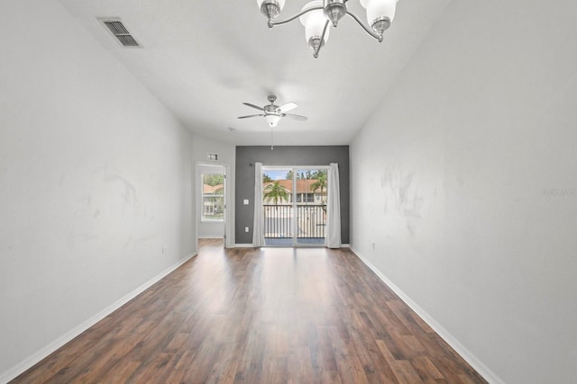 empty room featuring dark wood-type flooring and ceiling fan with notable chandelier