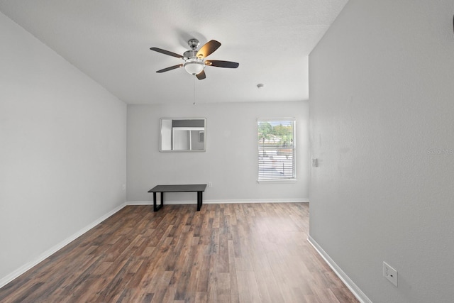 unfurnished room with dark wood-type flooring and ceiling fan