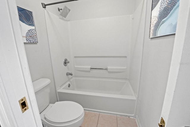 bathroom with washtub / shower combination, tile patterned flooring, and toilet