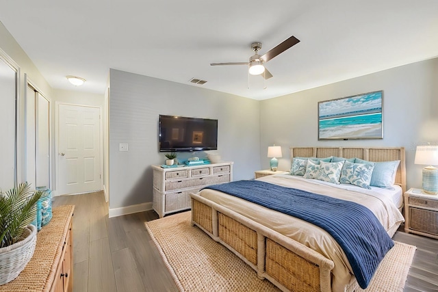 bedroom with dark hardwood / wood-style floors and ceiling fan