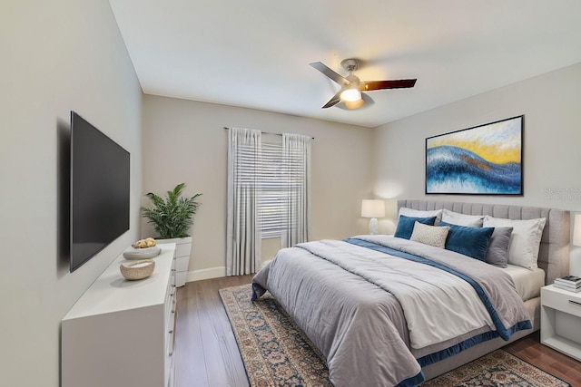 bedroom with dark hardwood / wood-style floors and ceiling fan