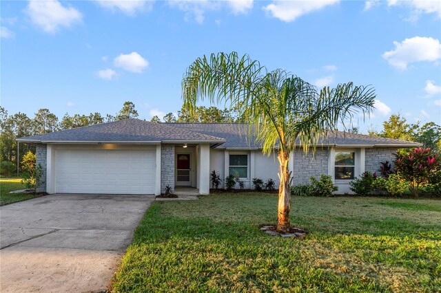 ranch-style home featuring a front lawn and a garage