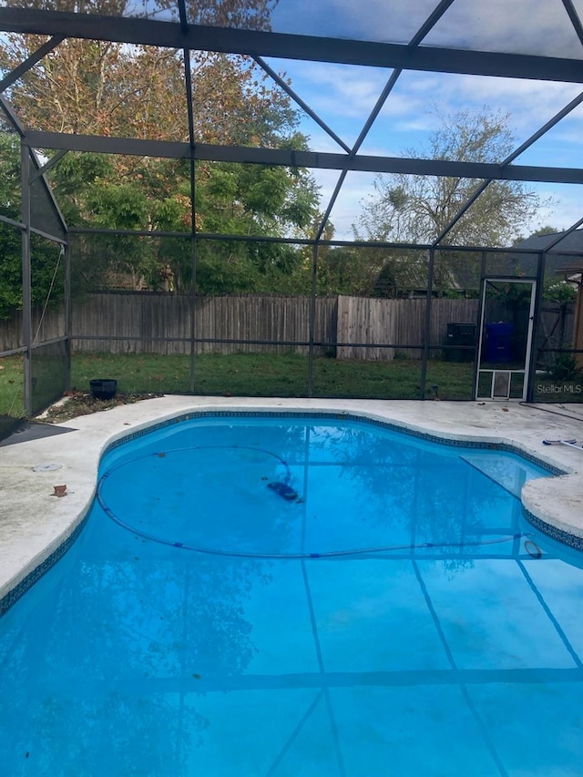 view of swimming pool featuring a lanai