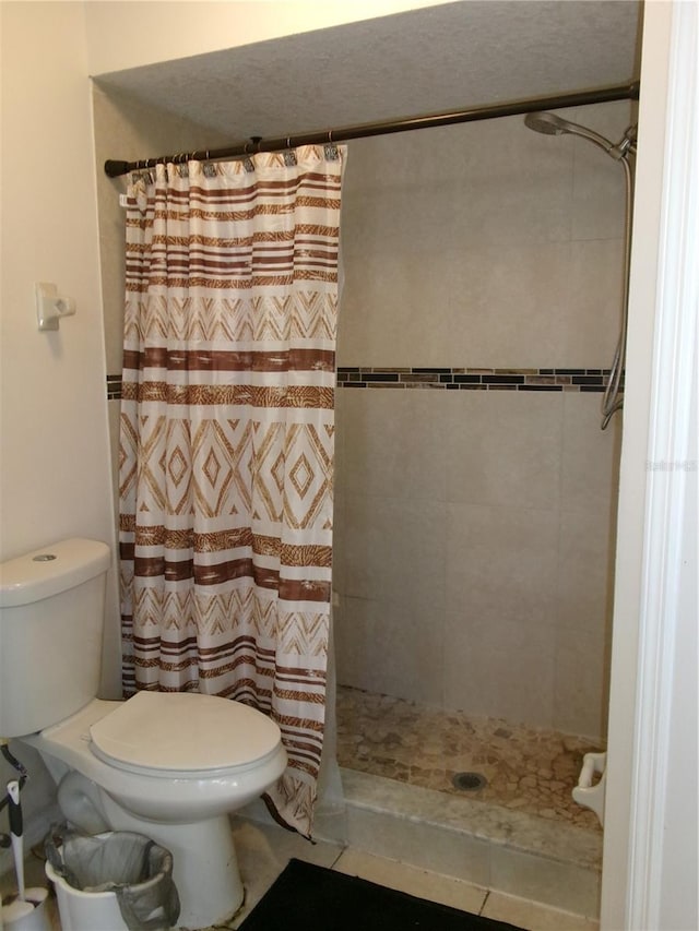 bathroom featuring toilet and walk in shower