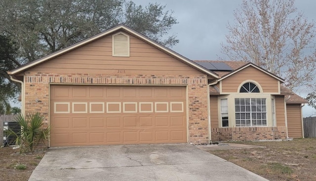 view of front facade with solar panels and a garage