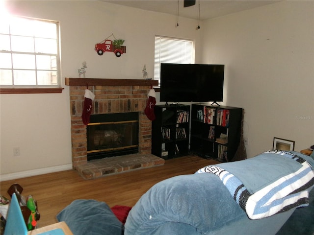 living room featuring hardwood / wood-style floors, plenty of natural light, and a fireplace