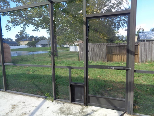 unfurnished sunroom with a water view