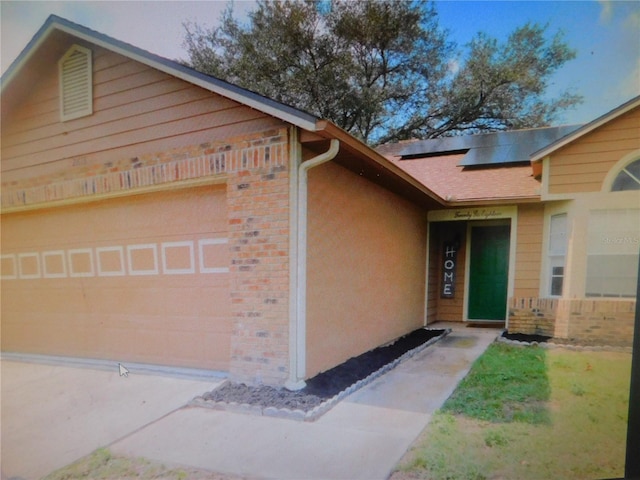 exterior space with solar panels and a garage