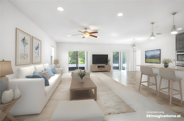 living room with light wood-type flooring and ceiling fan with notable chandelier