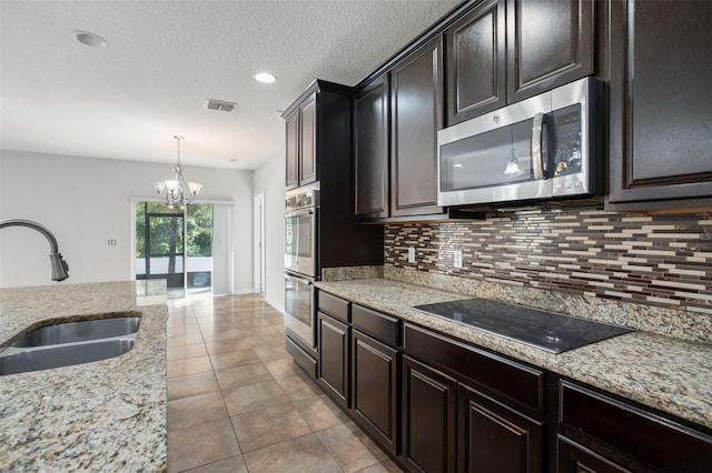 kitchen with pendant lighting, an inviting chandelier, sink, decorative backsplash, and stainless steel appliances