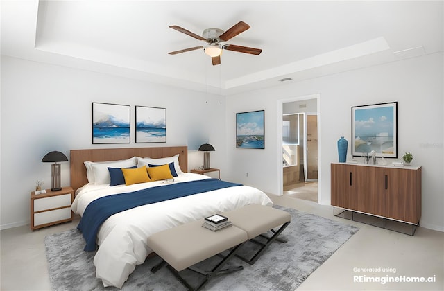 bedroom with connected bathroom, a tray ceiling, and ceiling fan