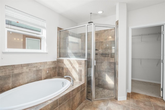 bathroom featuring tile patterned flooring and independent shower and bath