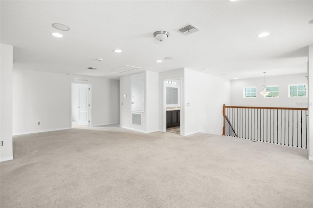 spare room featuring light colored carpet