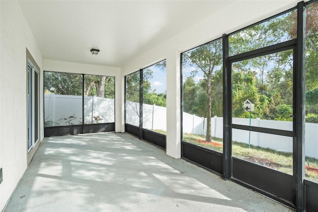 unfurnished sunroom featuring a wealth of natural light