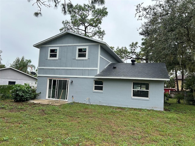 rear view of property with a lawn and a patio area