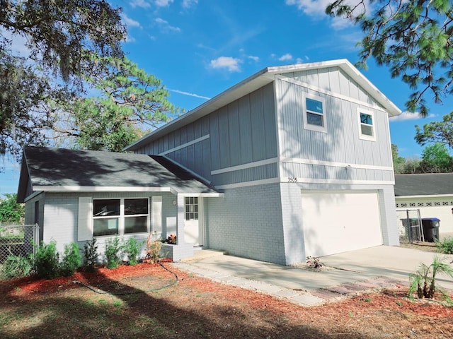 view of front of property with a garage, concrete driveway, and brick siding