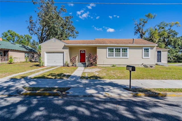 view of front of property with a front yard and a garage