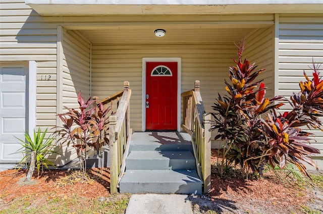 doorway to property with a garage