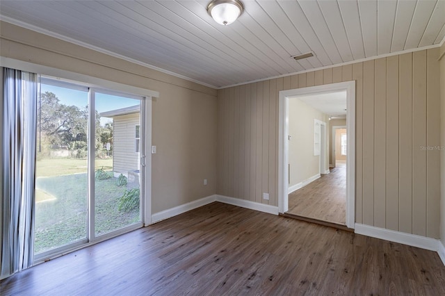 unfurnished room featuring wood ceiling, hardwood / wood-style floors, and crown molding