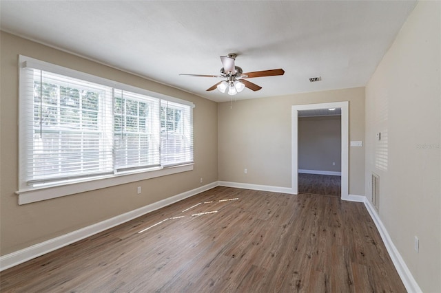 spare room with ceiling fan and dark hardwood / wood-style flooring