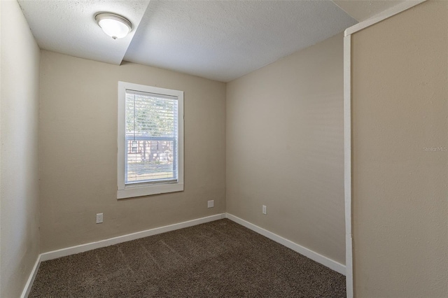 carpeted spare room featuring a textured ceiling