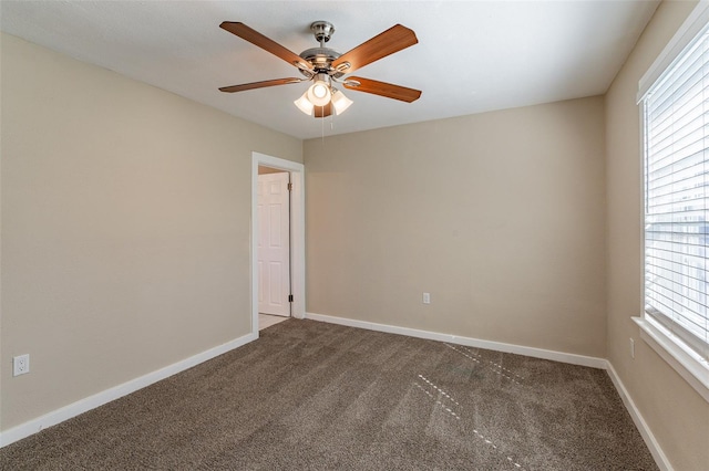 carpeted empty room featuring ceiling fan