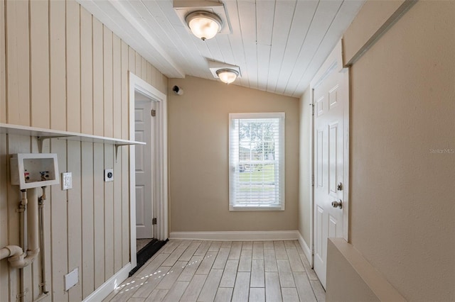 doorway to outside with light hardwood / wood-style flooring, wood ceiling, and vaulted ceiling