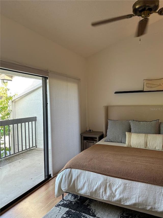 bedroom featuring vaulted ceiling, access to outside, wood finished floors, and ceiling fan