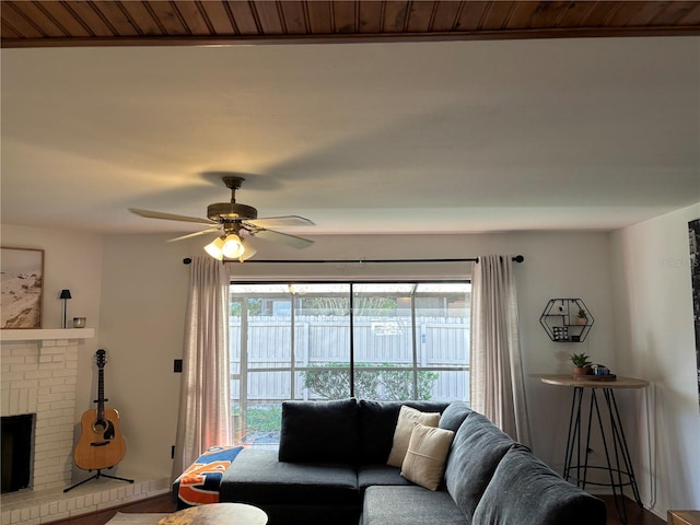 living area with a fireplace and a ceiling fan