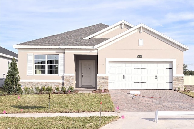 view of front of house with a garage and a front yard