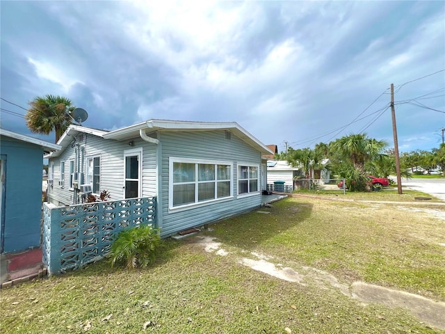 view of side of home with a lawn