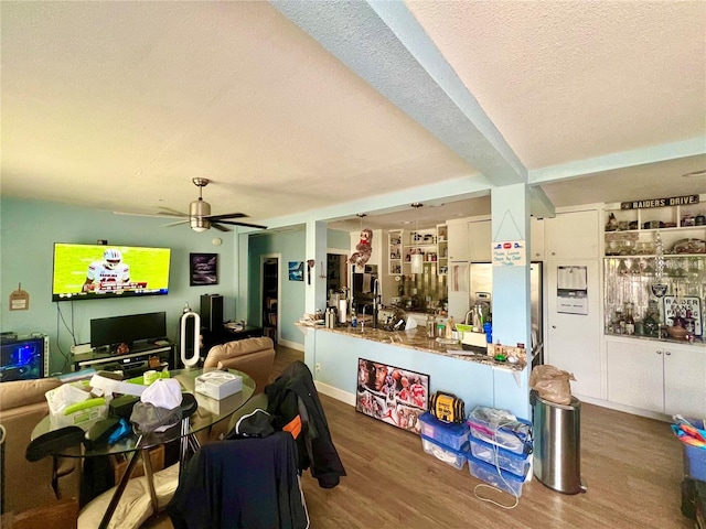 dining space featuring hardwood / wood-style floors, a textured ceiling, and ceiling fan