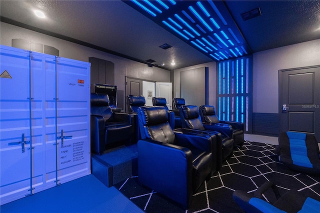 home theater room featuring a textured ceiling