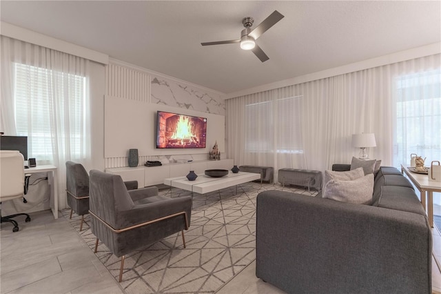 living room featuring ornamental molding and ceiling fan